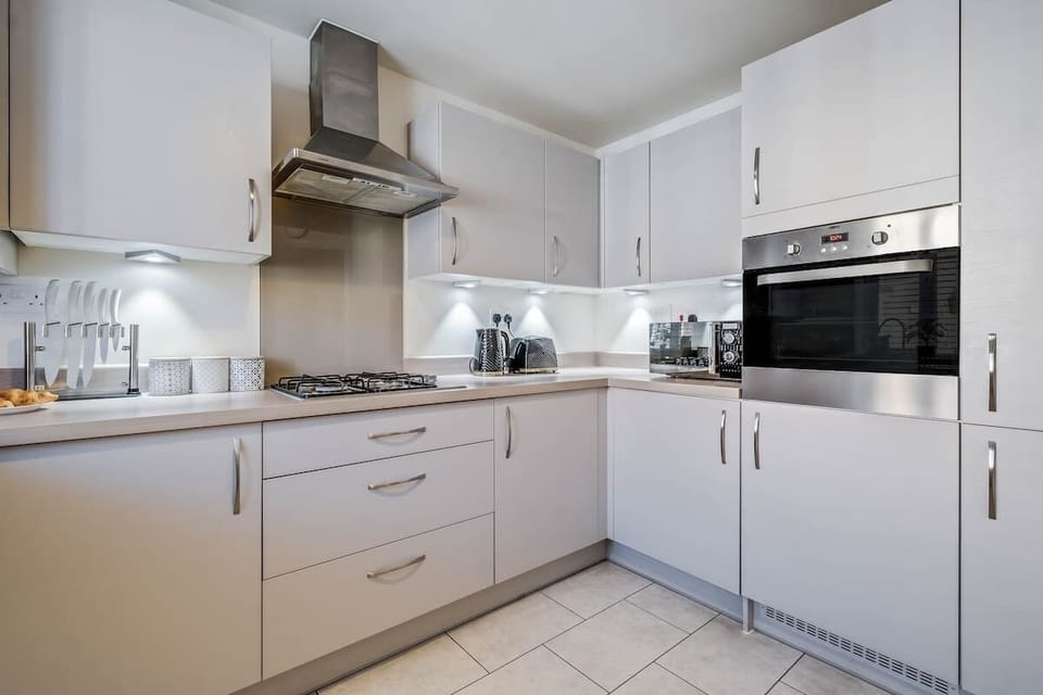 A well-equipped kitchen with all the essentials for your stay, including a washing machine