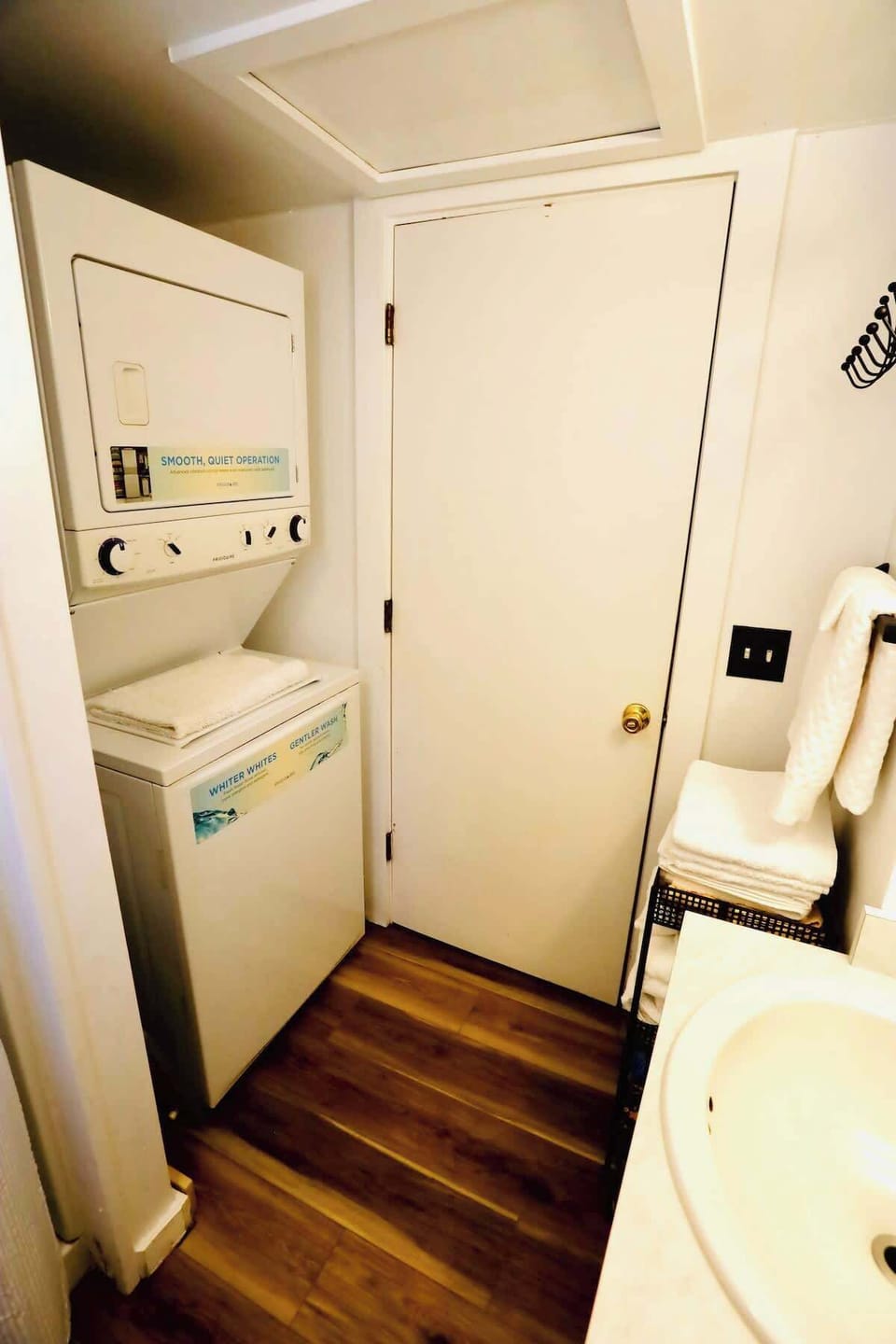 Compact laundry setup with a stacked washer and dryer conveniently located inside the bathroom—perfect for easy access during your stay.