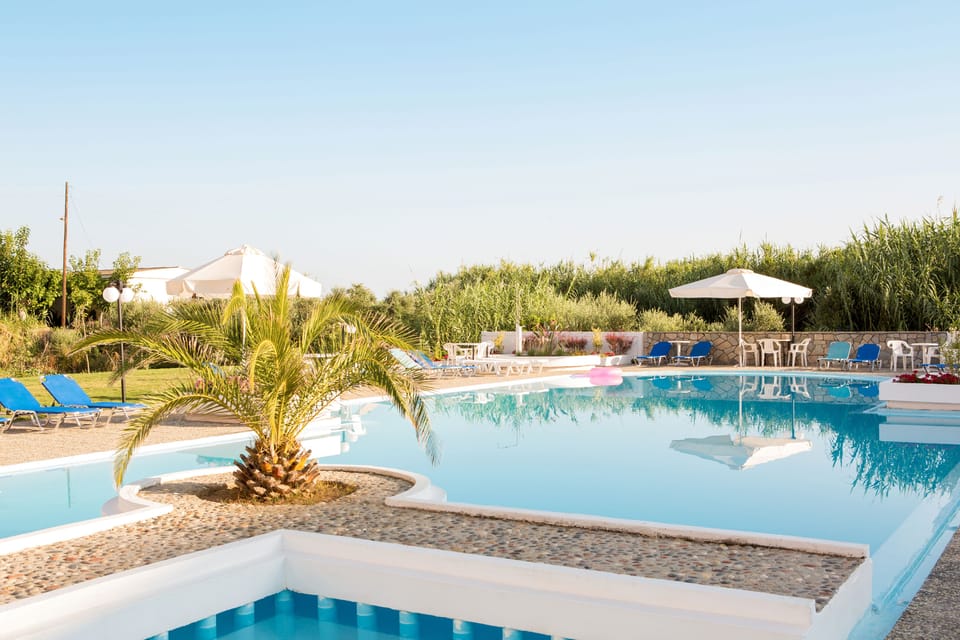 Seasonal outdoor pool, open 9:00 AM to 7:00 PM, pool umbrellas