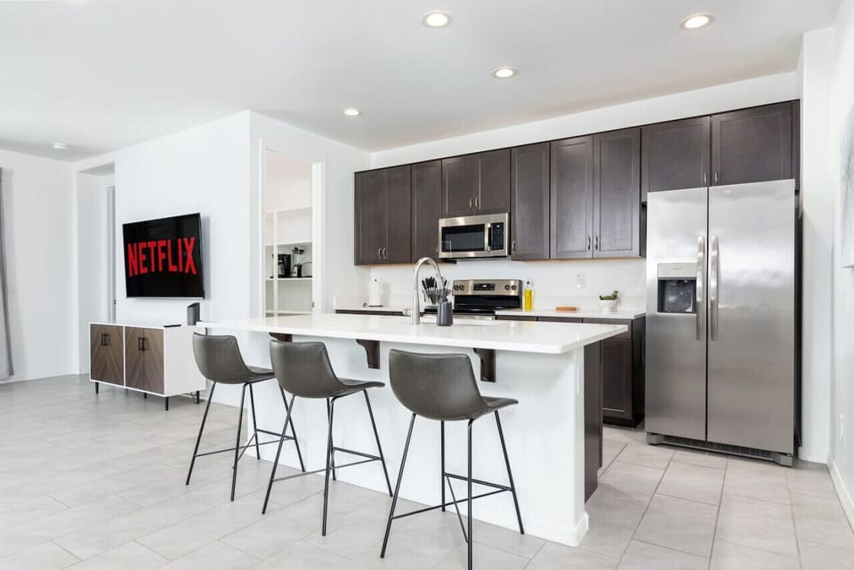 The kitchen has everything: modern cooking appliances and spacious quartz countertops!