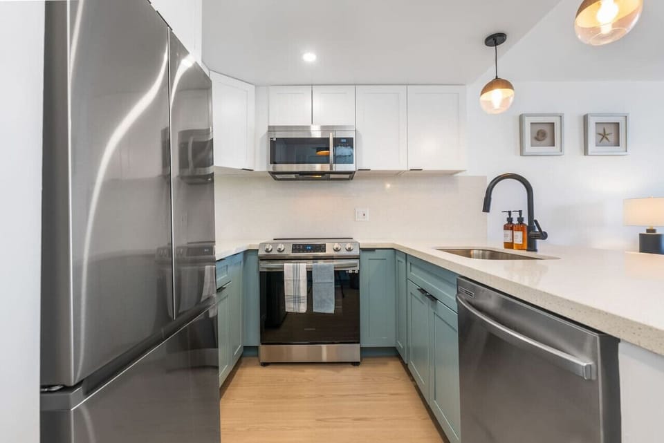 Newly renovated kitchen with brand new stainless steel refrigerator, range, microwave, and dishwasher.