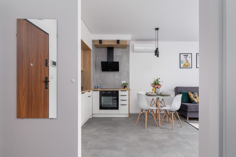 A wide-angle view of the living and dining spaces, showcasing an open-plan layout.
