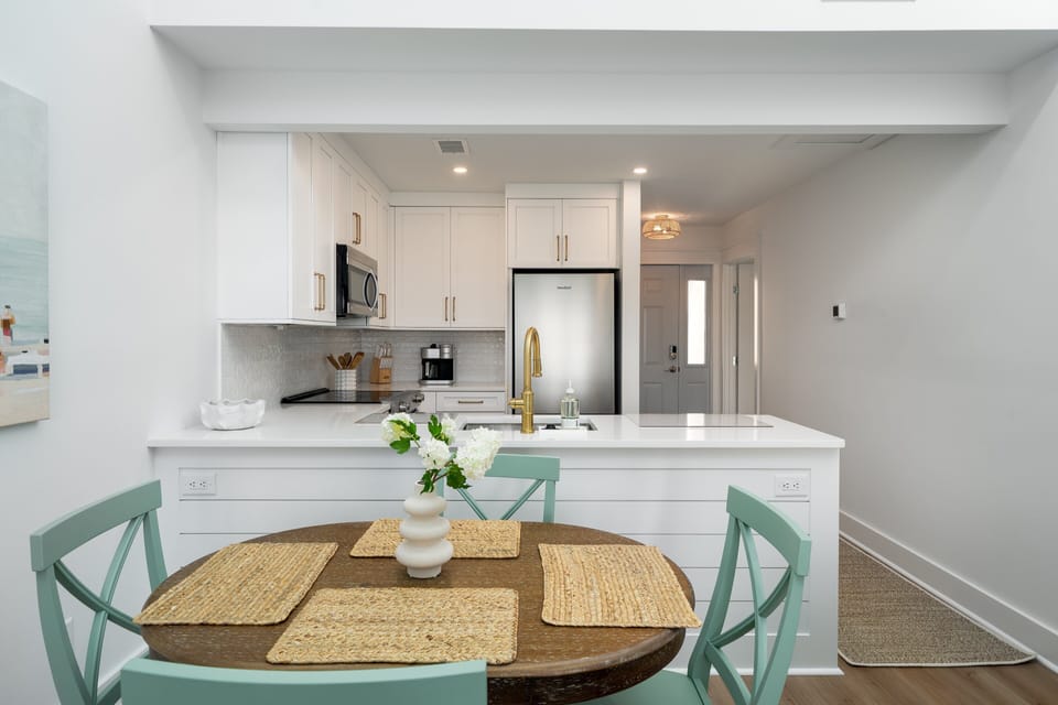 The dining table seats four and is open from the kitchen .