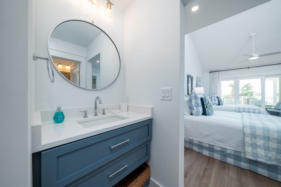 The guest bedroom has a separate vanity area