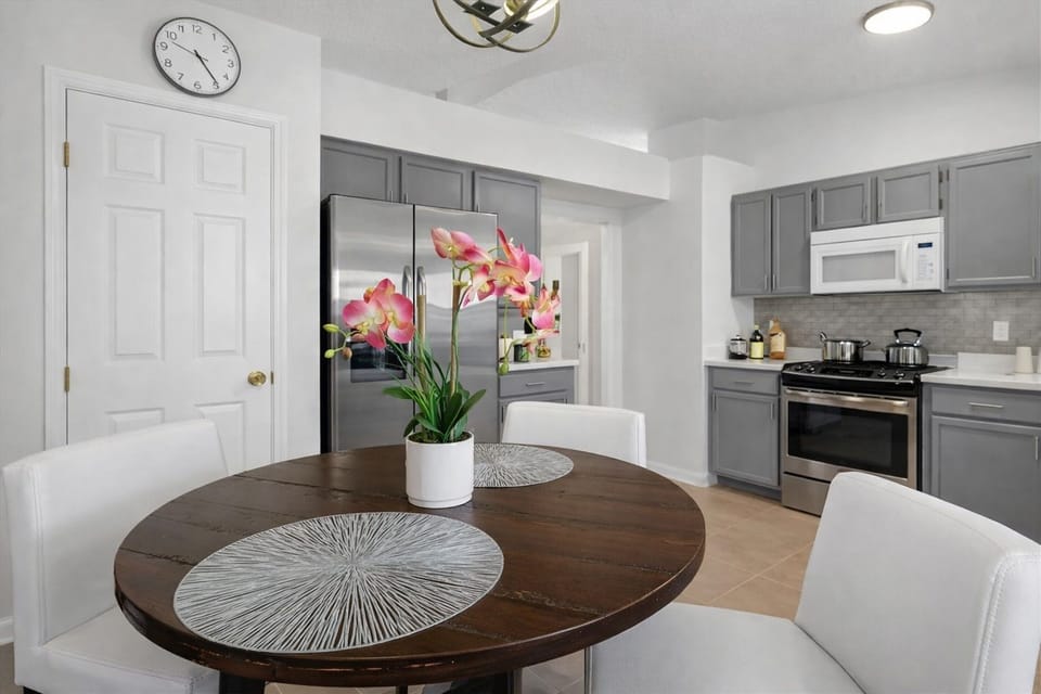 Modern kitchen with stainless steel appliances and a cozy dining area