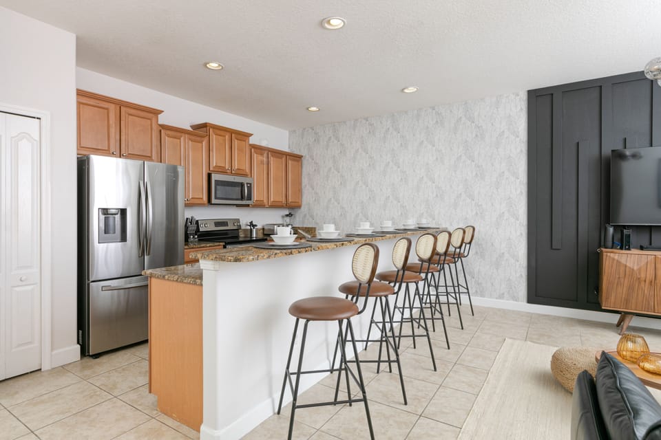 Our spacious kitchen is equipped with an island and bar stools