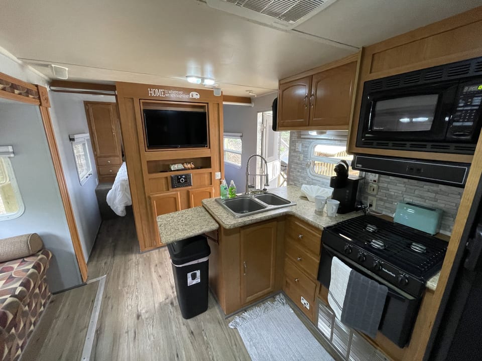 Everything you need to cook in this kitchen including a range and microwave.