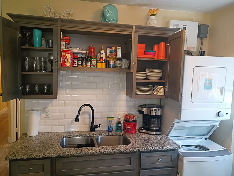 Cabinets have dishes, cups, plastic, spices, coffee, and lots of extras.