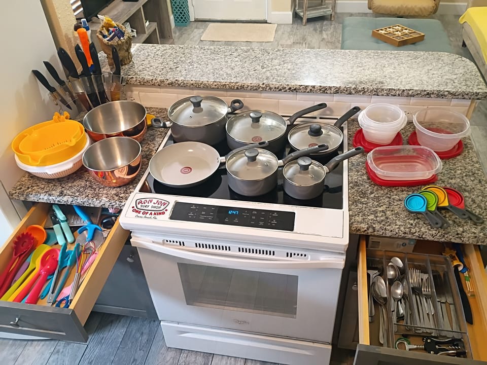 Glass-top stove, nonstick pots/pans, silicone utensils, mixing bowls, silver