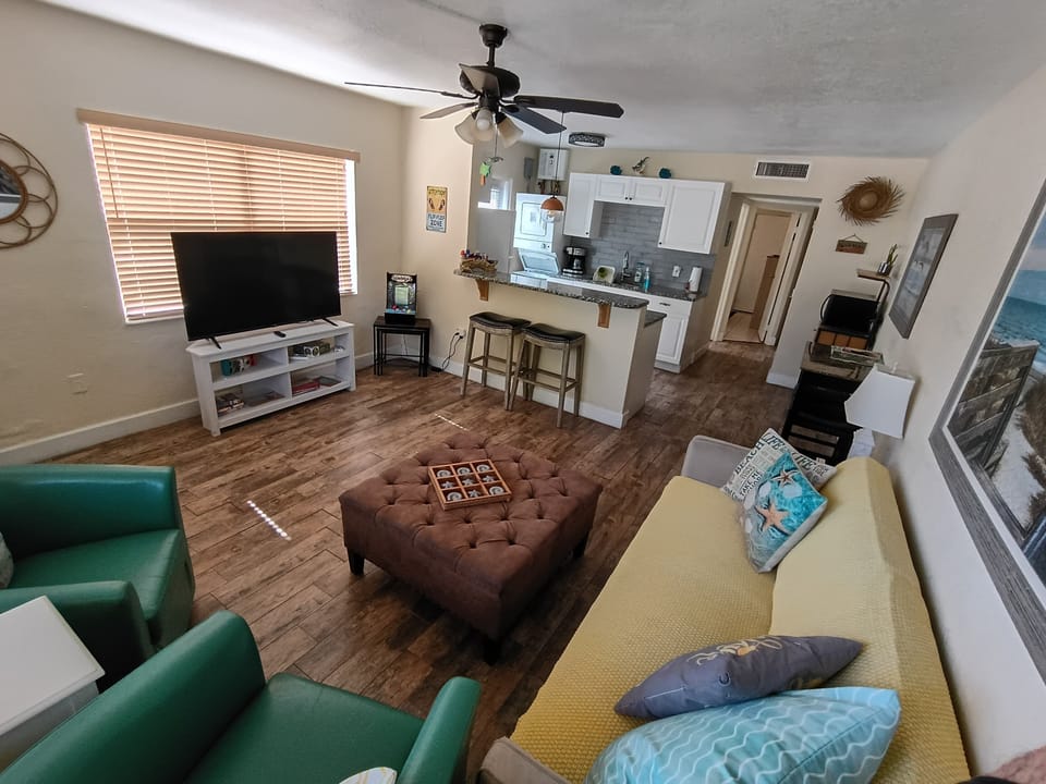 Plenty of room, seating, fold down futon couch, open kitchen design, and Roku TV