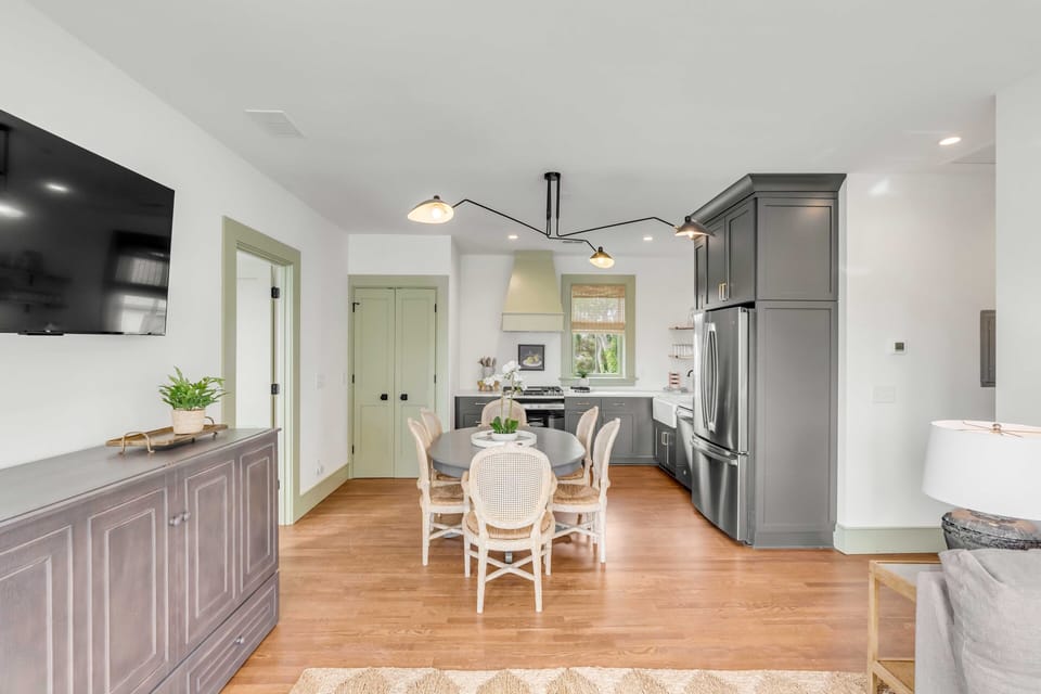 Living, Dining, Kitchen, & Laundry. Living Room features a Queen Murphy Bed under the TV.