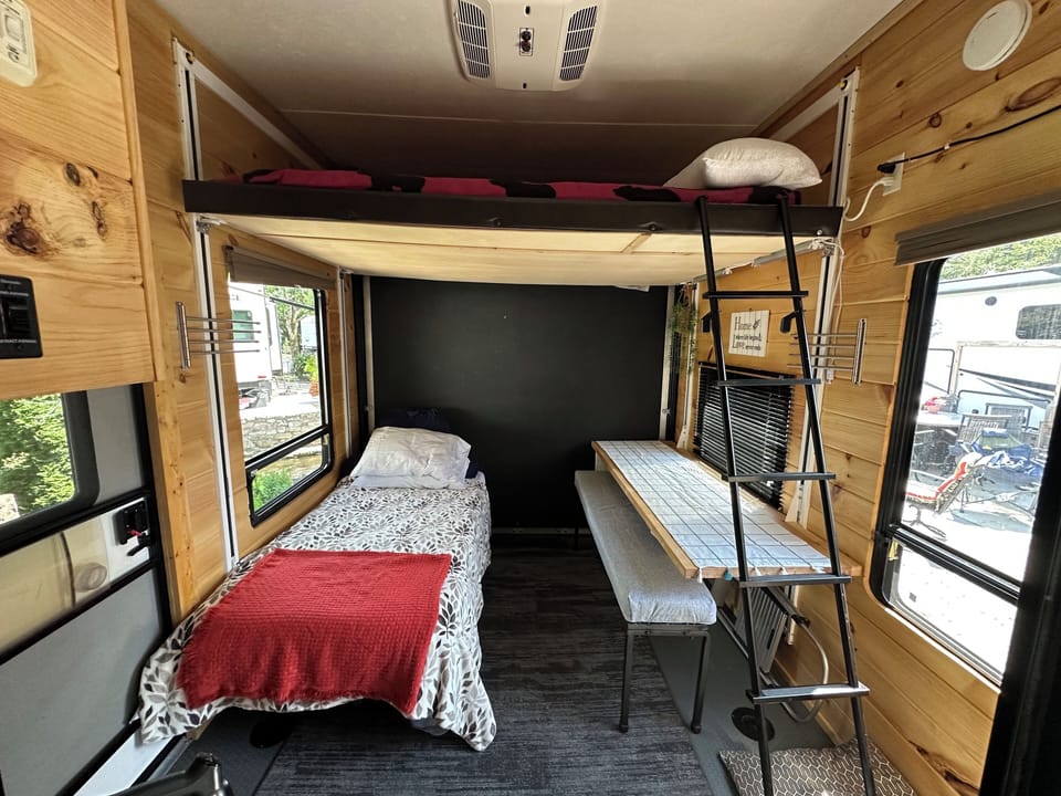 Queen loft bed above the dining and twin sleeping area.