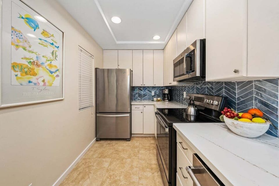 Open kitchen design with a breakfast bar and sleek finishes for casual dining.