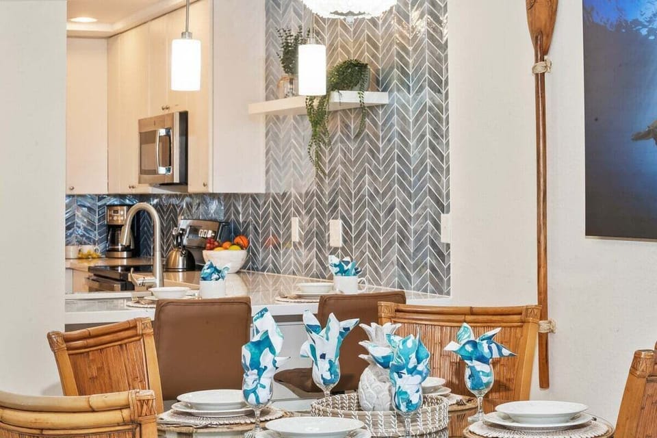 Modern kitchen with stainless steel appliances, granite countertops, and a breakfast bar.