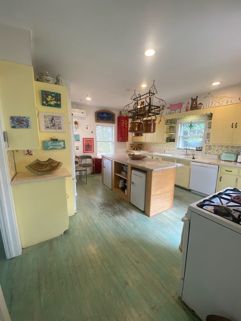 country kitchen with island with extra refrigerator and freezer below