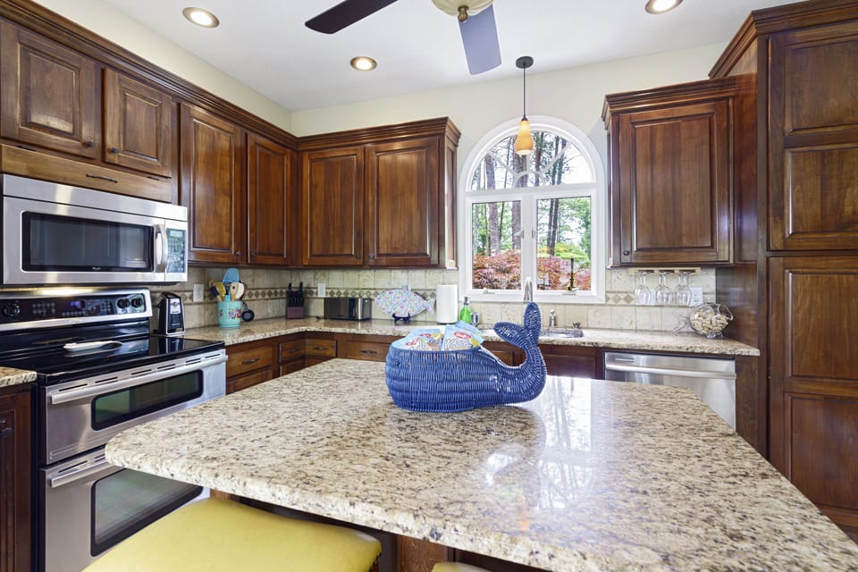 full kitchen with granite countertops and stainless steel appliances