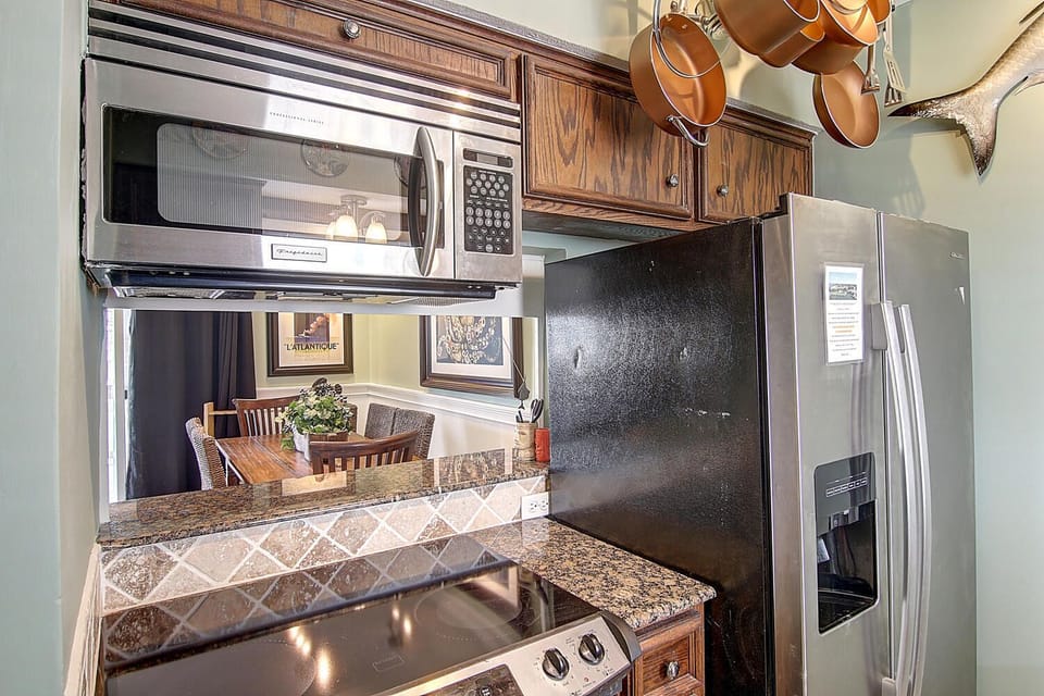 Your fully equipped kitchen features granite countertops, stainless steel appliances, and charming copper cookware for memorable meal preparation.