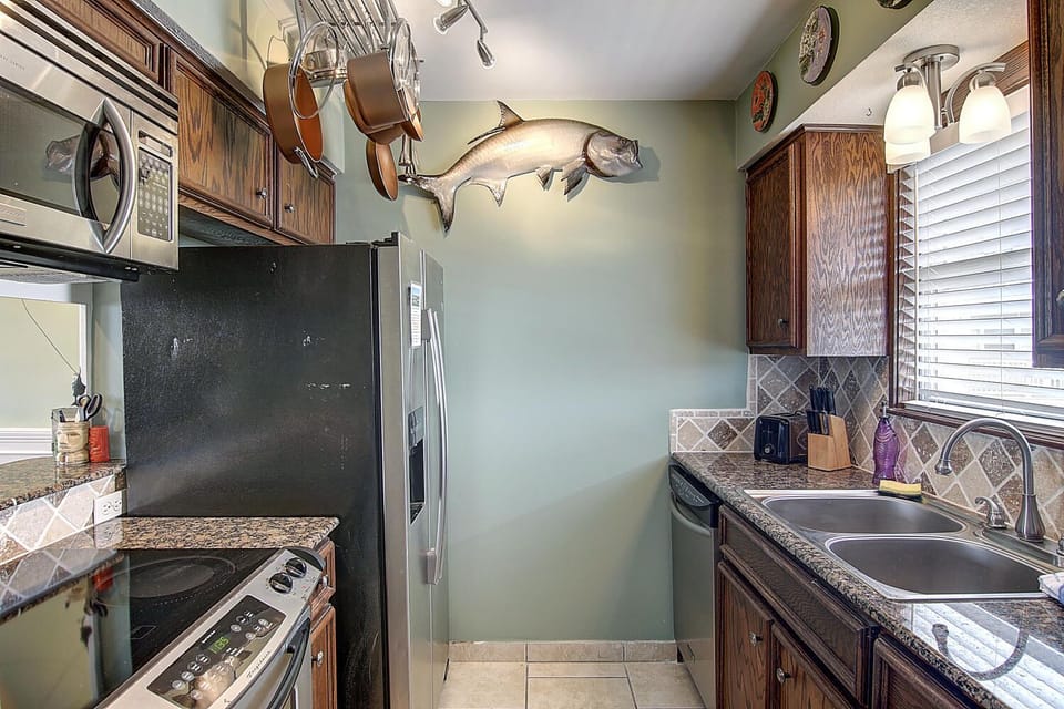 Whip up delicious meals in your fully equipped galley kitchen featuring granite counters, stainless appliances, and charming nautical touches.