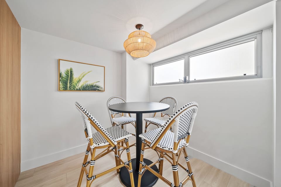 Dining are with table and 4 chairs - Share meals or plan your Waikiki adventures around this cozy dining table, set beneath warm lighting and surrounded by clean, modern island-inspired design.