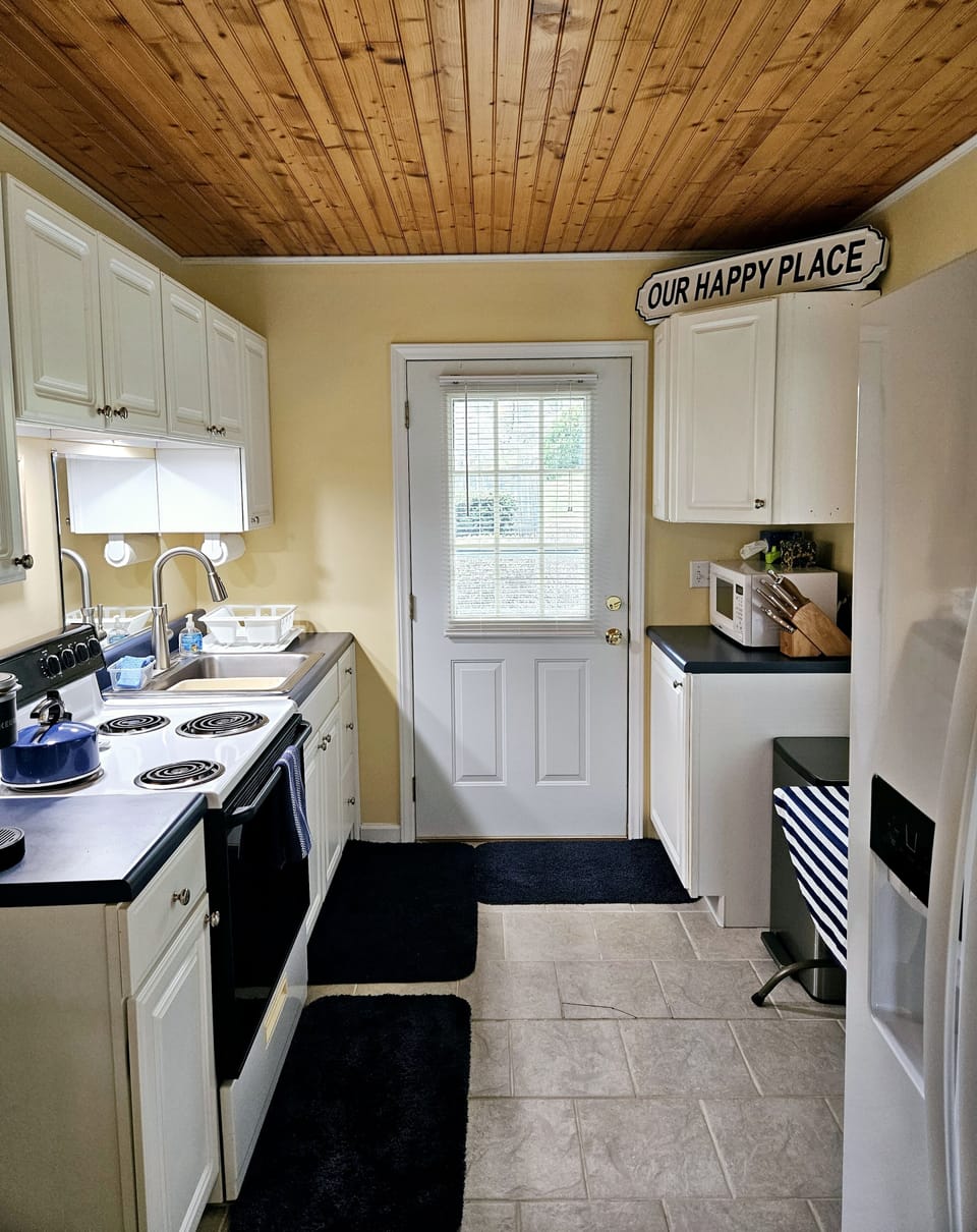 Fully stocked kitchen with many spices and cooking tools.