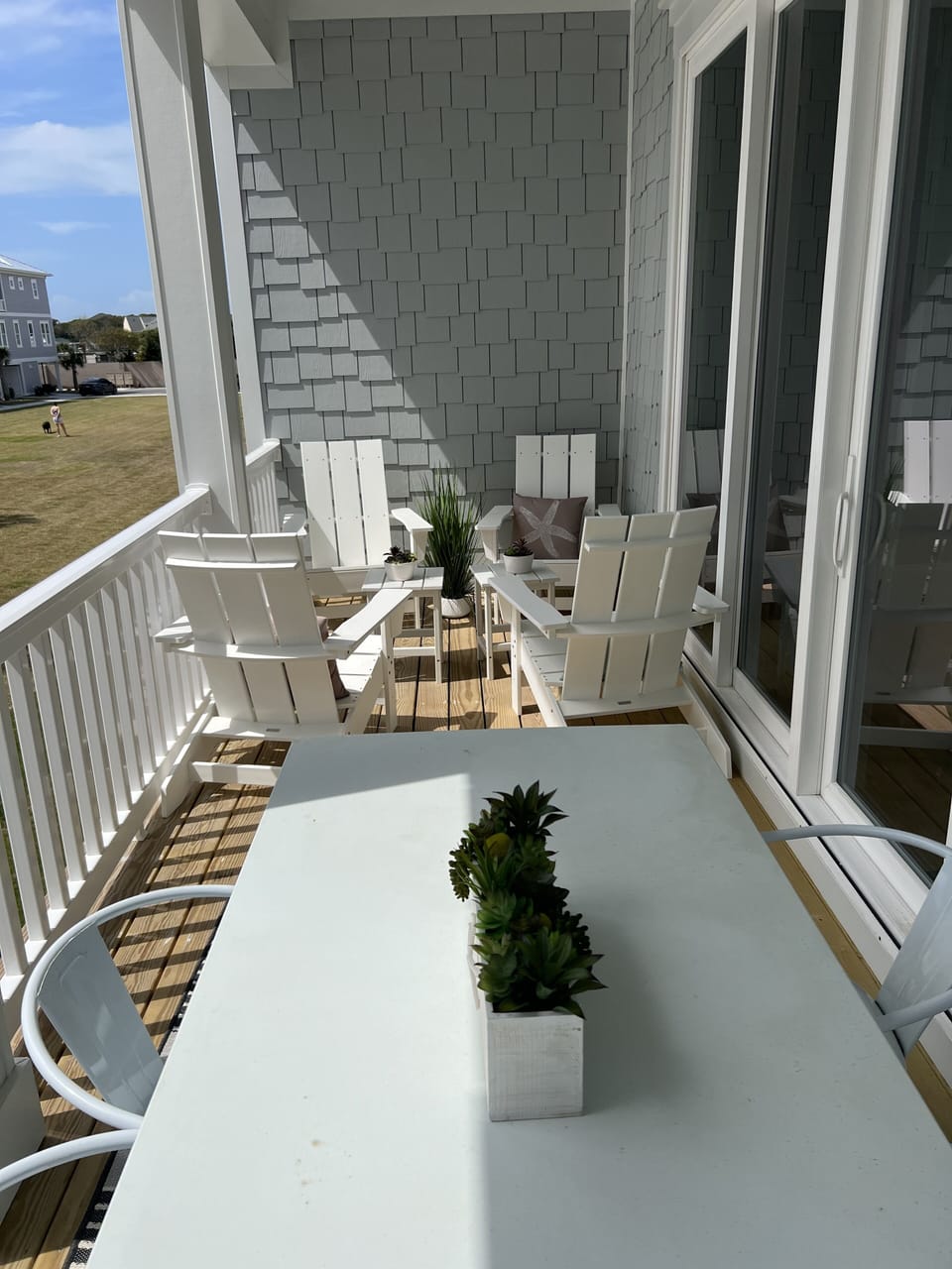 2nd level porch with dining area overlooking the yard and pool.