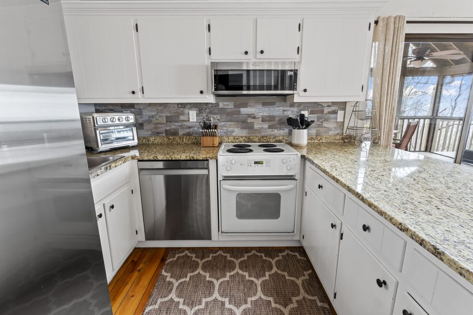 Kitchen with oven/stove, microwave, dishwasher, air fryer, fridge/freezer