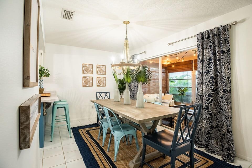 Alternate dining area angle highlighting the farm table and metal accent chairs