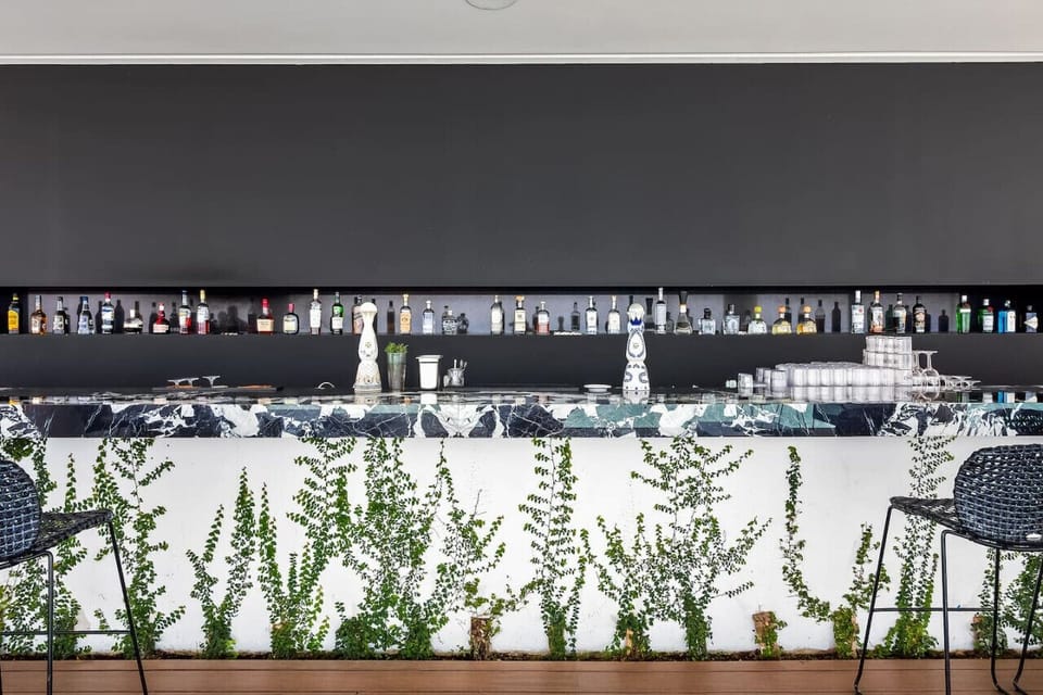 [Rooftop Bar] Unwind at the bar with panoramic views of the mountains, ocean, and city.