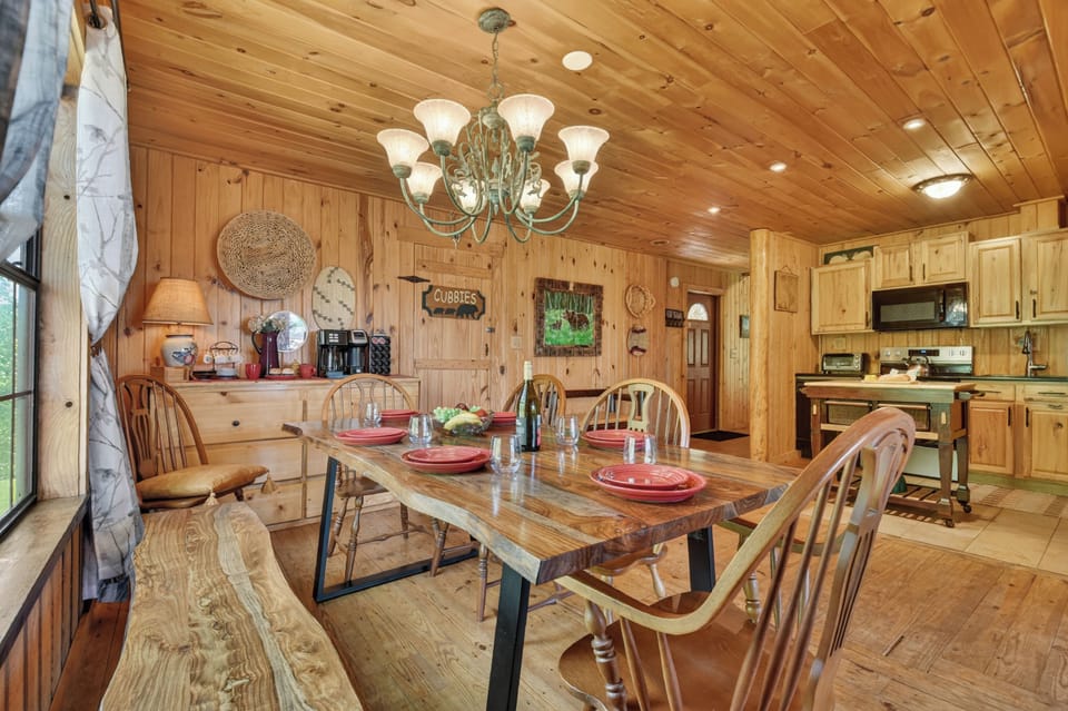 The open dining and kitchen area at this North Georgia Mountain cabin rental makes it easy to gather, laugh, cook, and enjoy time together