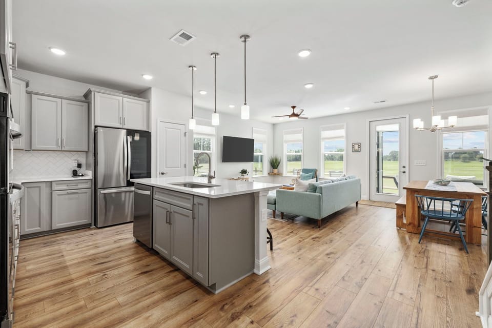 Main level open living space with full kitchen, living and dining areas.