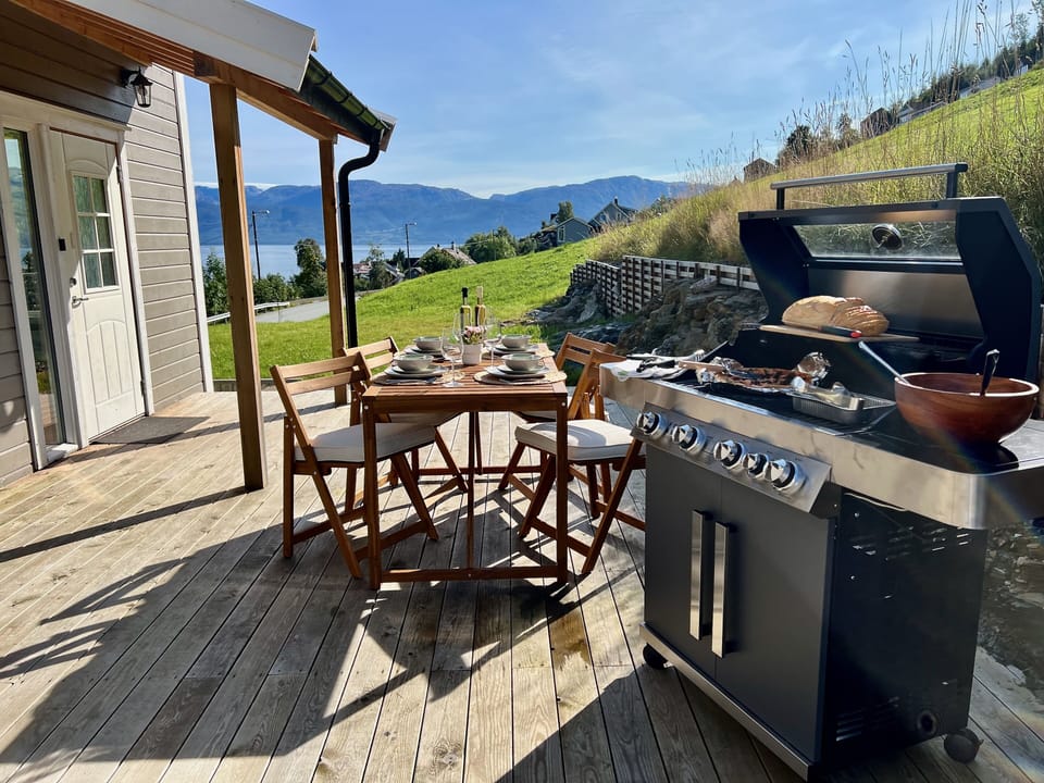 Al fresco dining with mountain and fjord backdrop