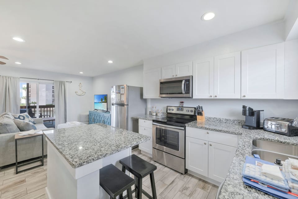Your modern kitchen features granite countertops, stainless steel appliances, and flows seamlessly into your bright living space.