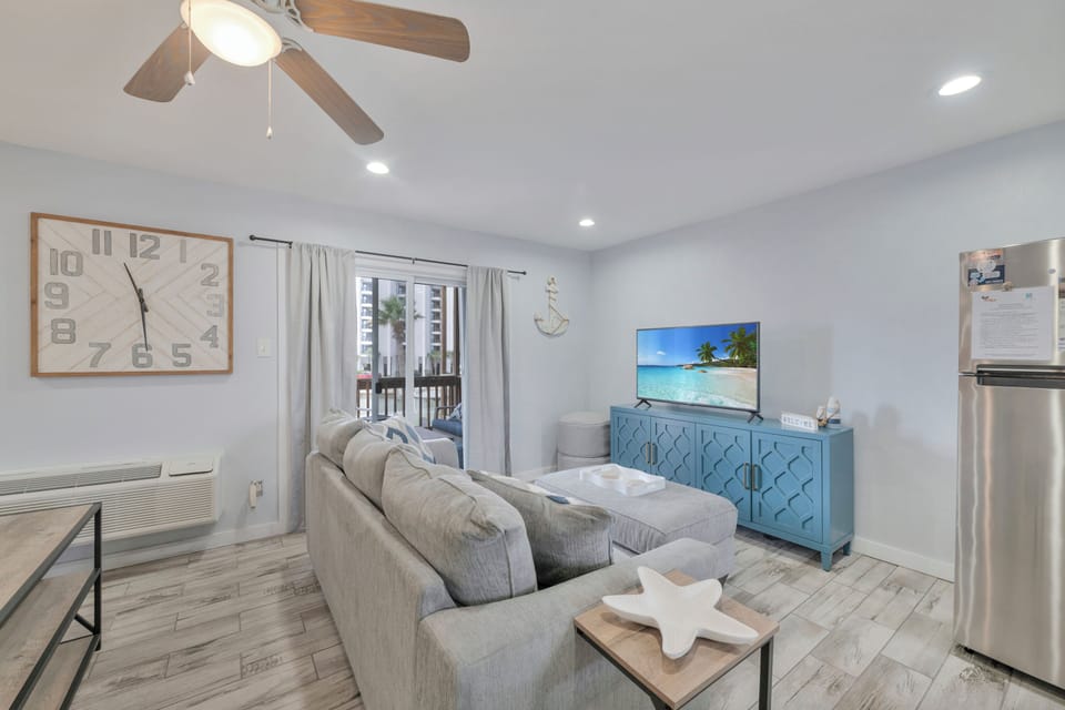 Relax in your bright living space with coastal touches and modern comfort, perfect for unwinding after beach days.