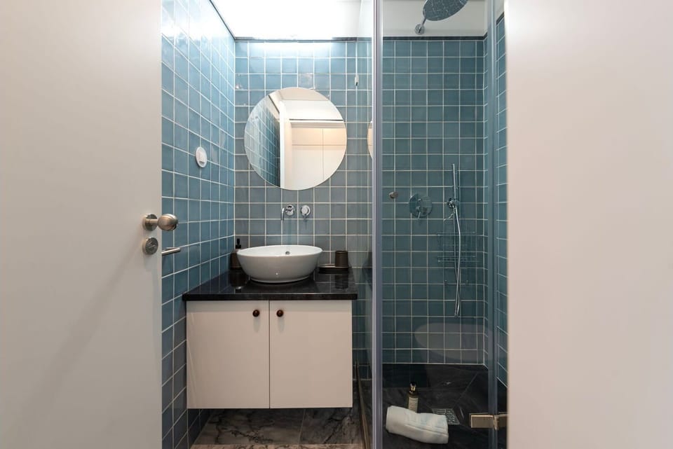 Refresh in a bright, modern bathroom featuring crisp blue tiles and a spacious, invigorating walk-in shower.
#Bathroom #WalkInShower #LovelyStay