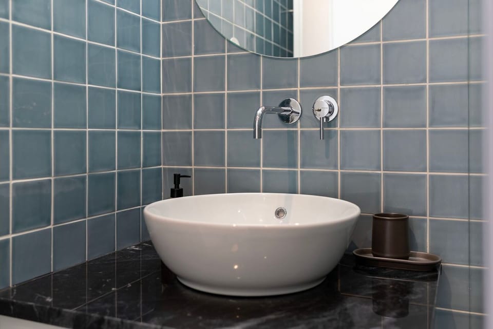 The sleek, modern bathroom invites you to refresh with its stylish basin and contemporary tiling.
#Bathroom #ModernDesign #LovelyStay