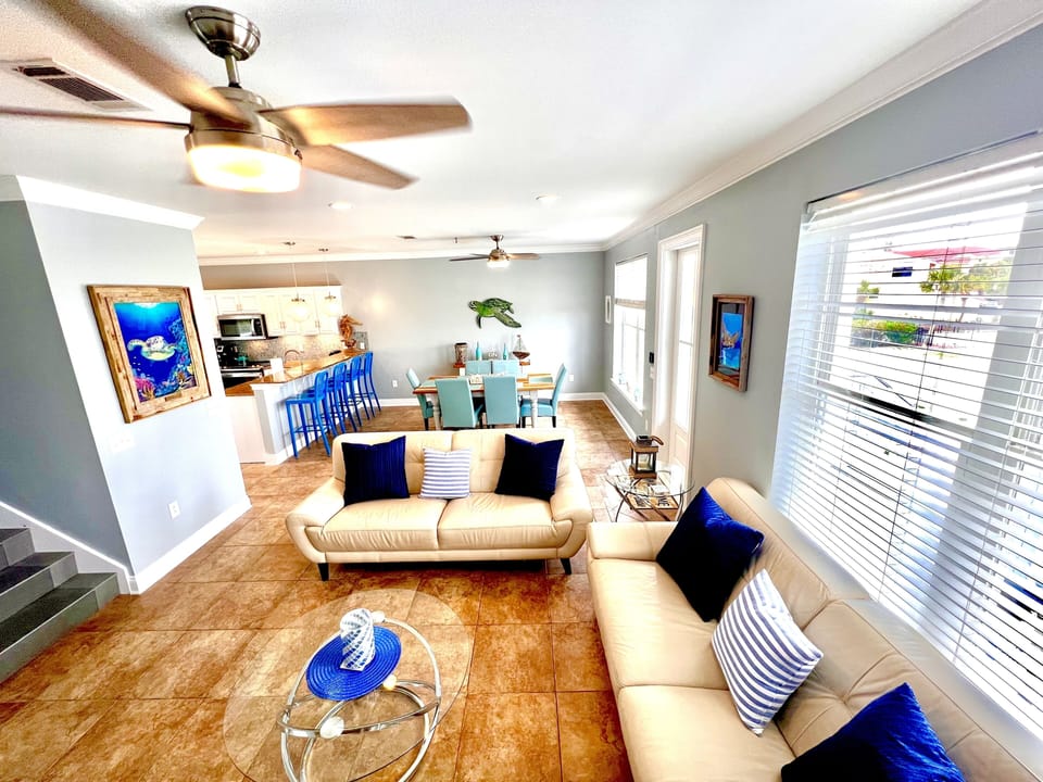 Living area with beautiful Gulf water views, 2 leather couches and a 55 in TV. 