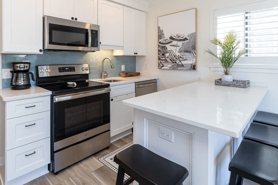 Plantation shutters flood the kitchen and island with plenty of warming sunshine!