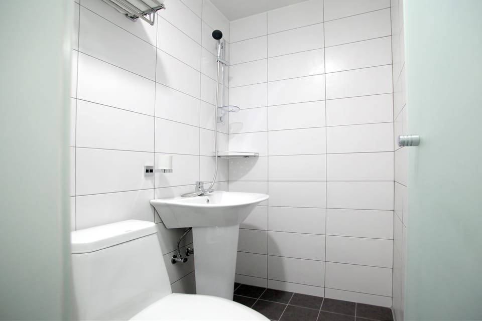 Shower, hair dryer, slippers, towels