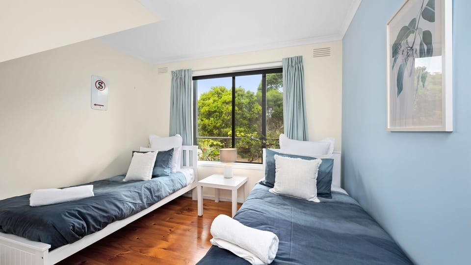 Bedroom1 with two single beds with lots of natural light 