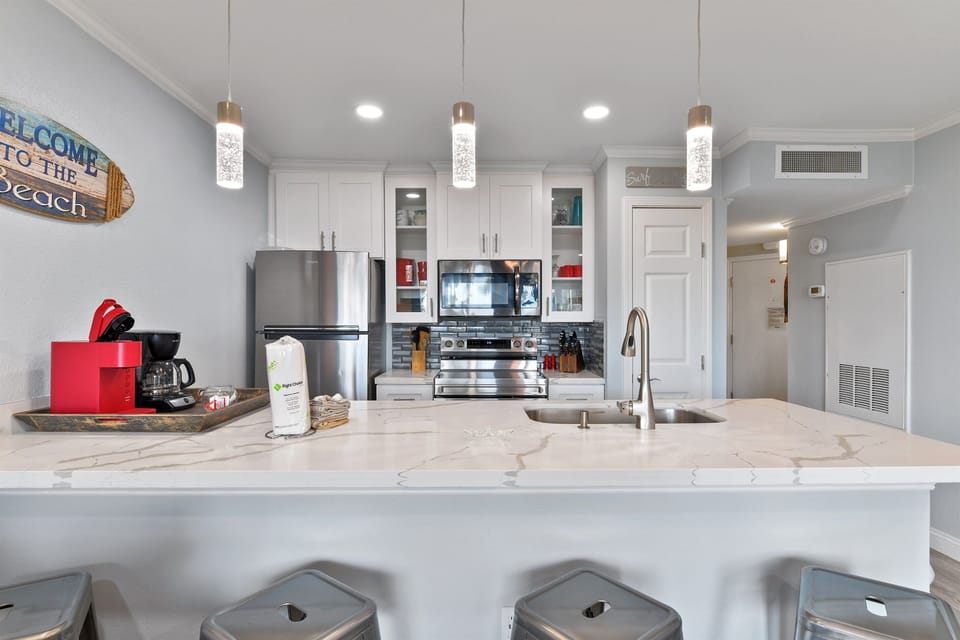 Updated lighting, beautiful backsplash and glass door cabinets!