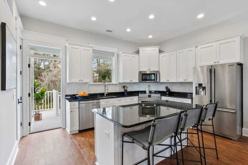 Kitchen | Fully Stocked Kitchen with Island and Bar Seating | Main House — First Floor