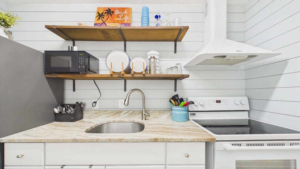 Fully applianced kitchen with coffee essentials and full fridge
