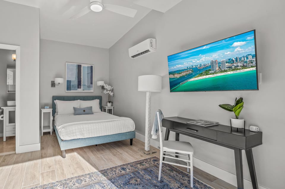 The fourth bedroom features a queen size bed and a smart TV.