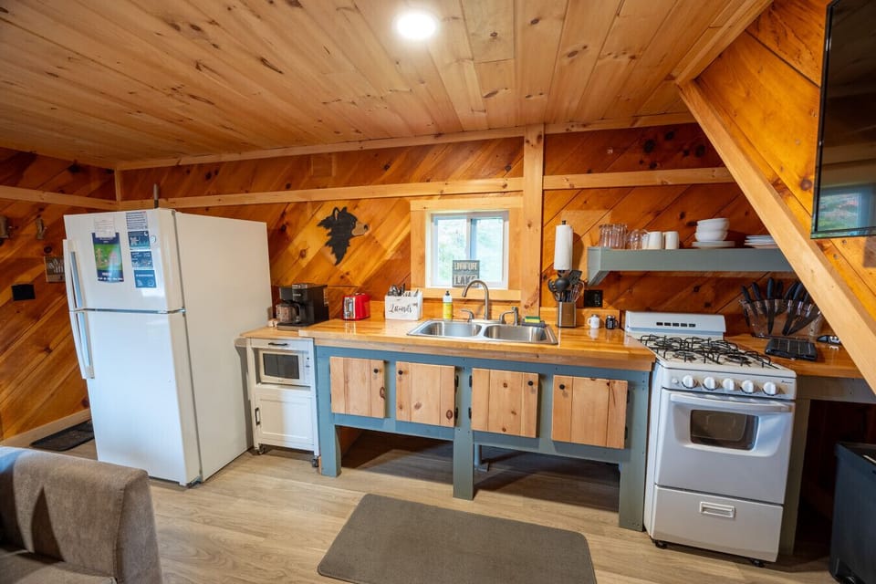 Charming cabin kitchen with all the essentials — cook, relax, and feel right at home.