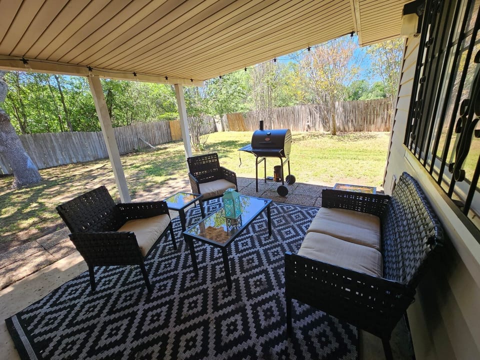 back patio with seating for 4. additional Bagged chairs are located in the shed