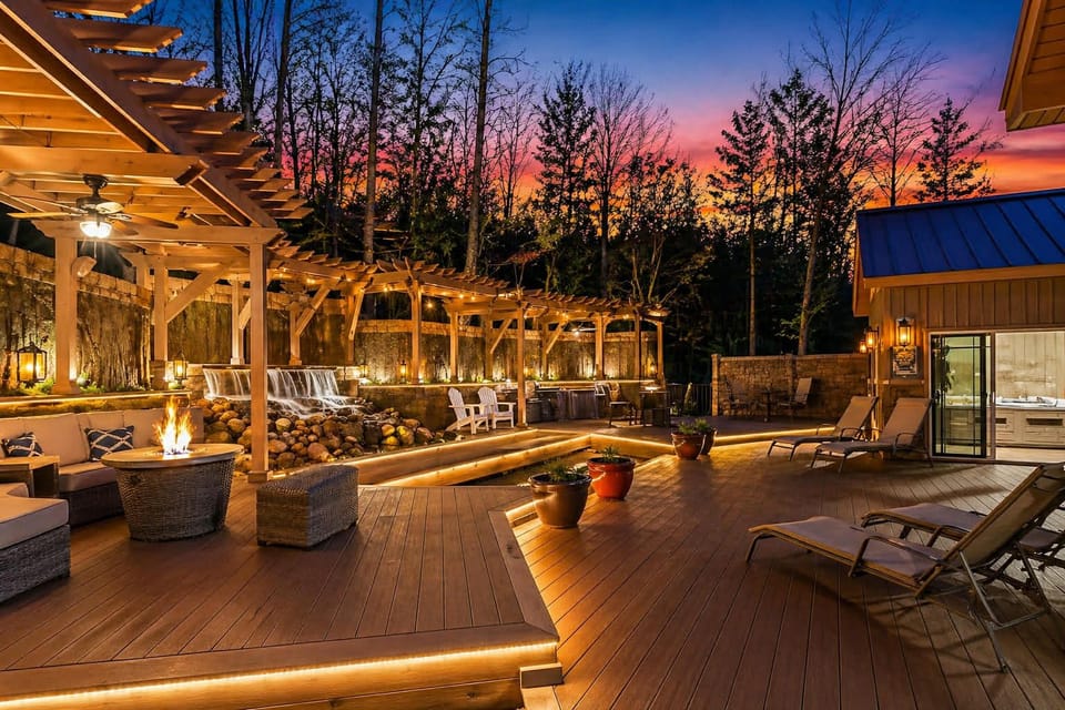 Magazine-worthy backyard space with waterfalls, fishpond, outdoor kitchen, and plentiful seating
