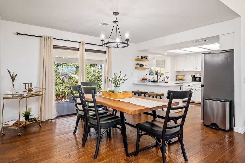 Beautifully lit dining table with 4 chairs and bench seating