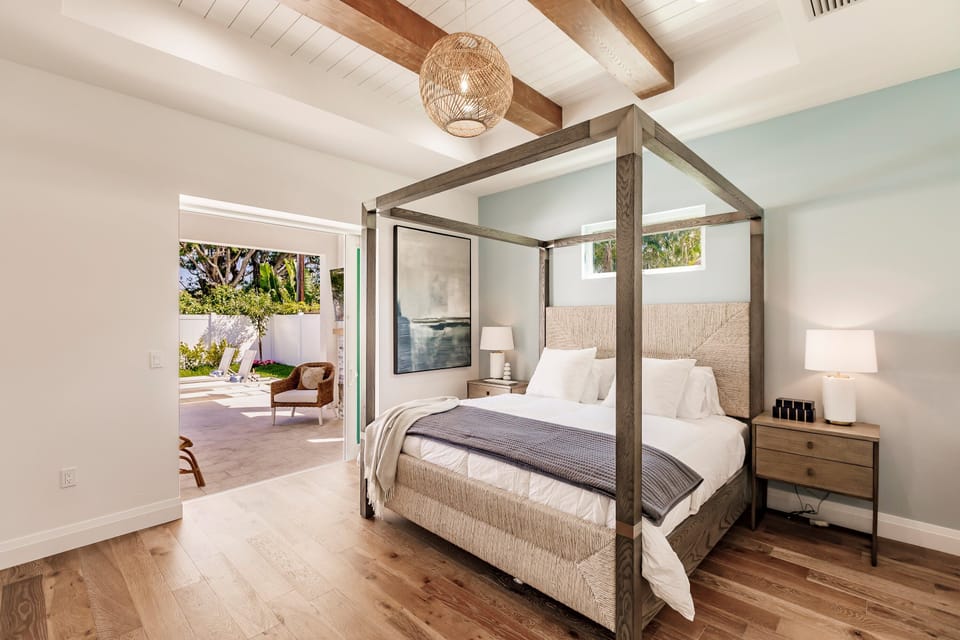 Canopy style king bed with private entrance to patio