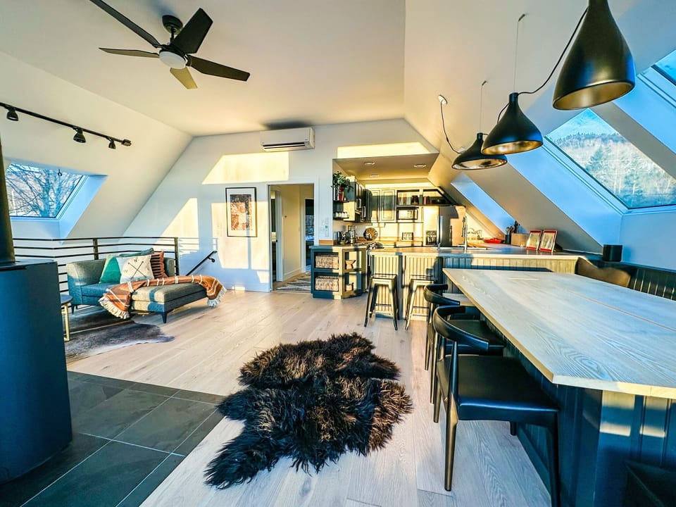 A view of the kitchen, living room, and hallway to the bathroom/bedrooms