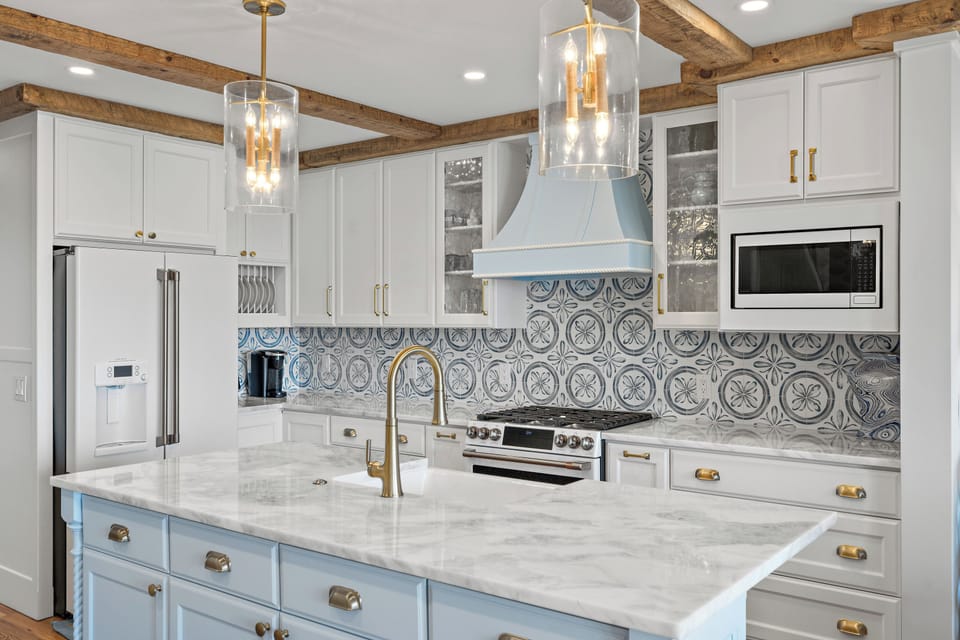 The kitchen offers ample counter space, stainless steel appliances, is fully stocked, and provides beautiful views of the golf course